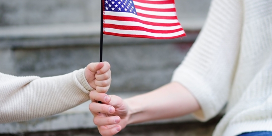 Child and parent with American flag