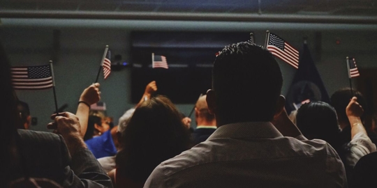 crowd holding American flags
